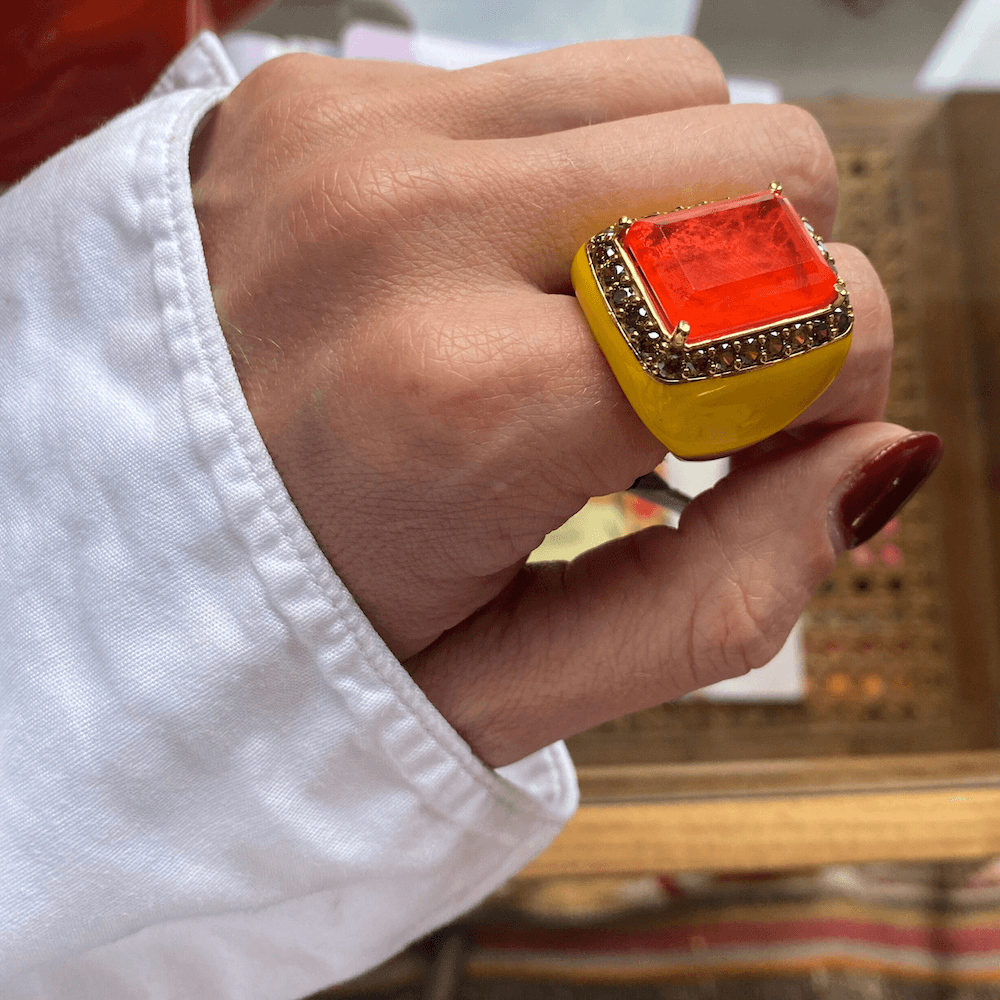 Yellow gold plated oversized statement ring with canary yellow enamel, large orange doublette center stone and peridot green zirconia halo, shown on hand — ANNICK by Giadan for Le.Paul Jewelgarden