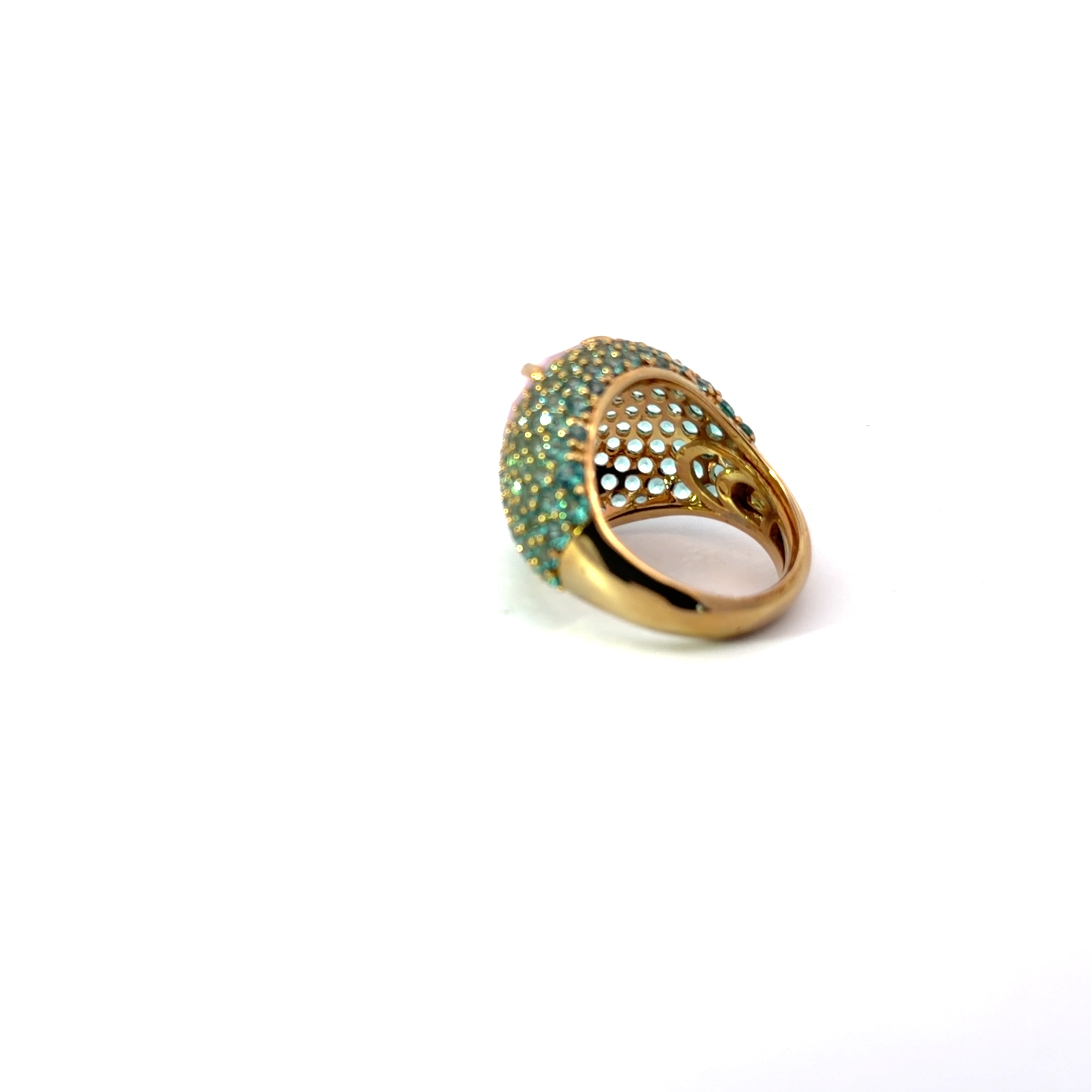 CELESTE statement ring, pear-cut pale pink center stone with green pavé zirconias, side view showing domed gold plated band