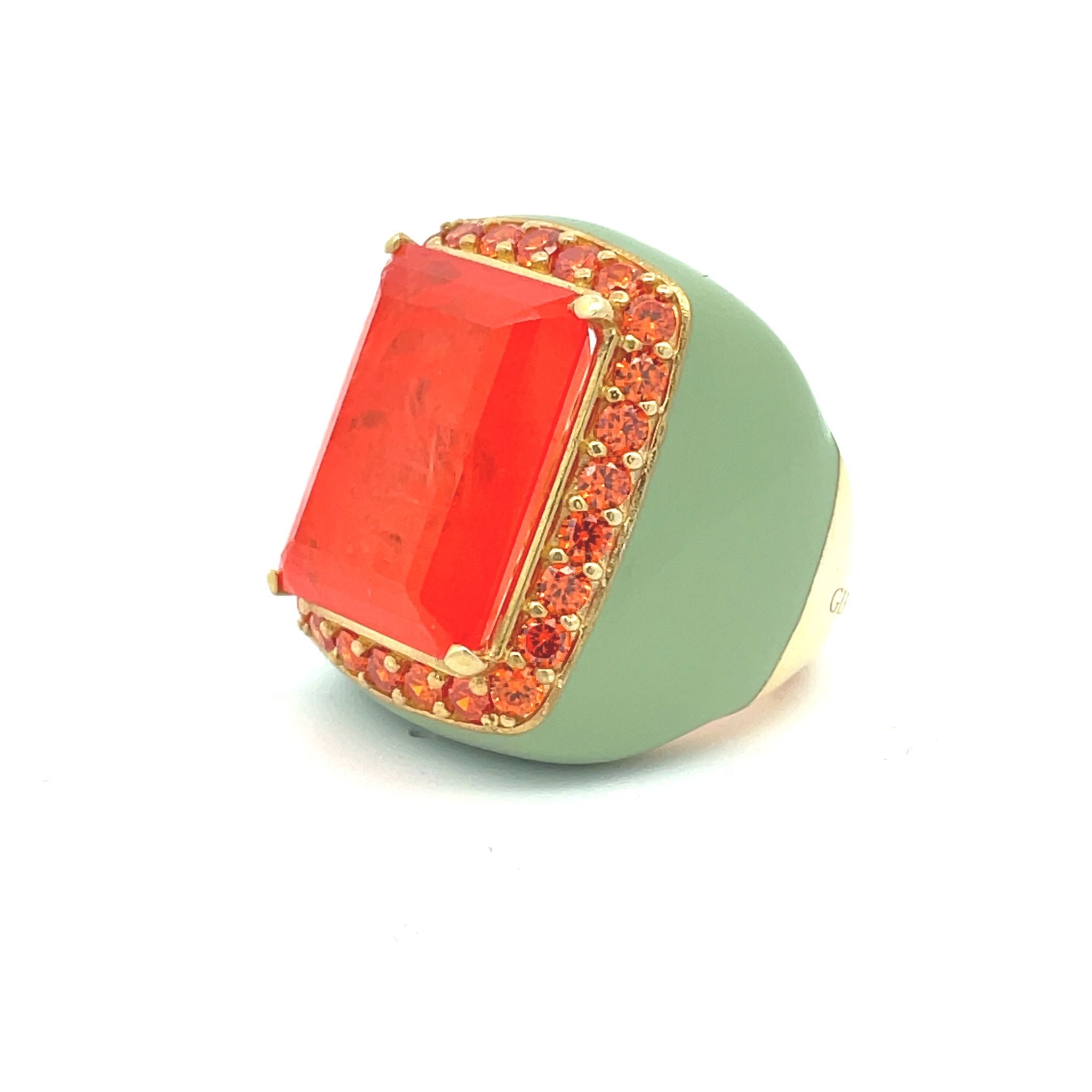 Sideview of FREDDY - a yellow gold plated oversized statement ring with pastel green enamel, large orange doublette center stone and orange zirconia halo — by Giadan for Le.Paul Jewelgarden
