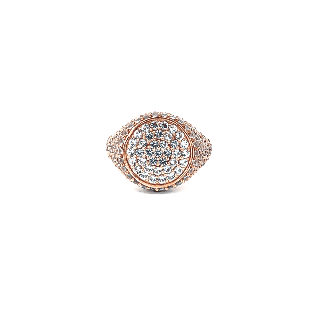 A rose gold plated sterling silver ring with a band adorned with white zirconias on the top and sides, displayed against a white background.
