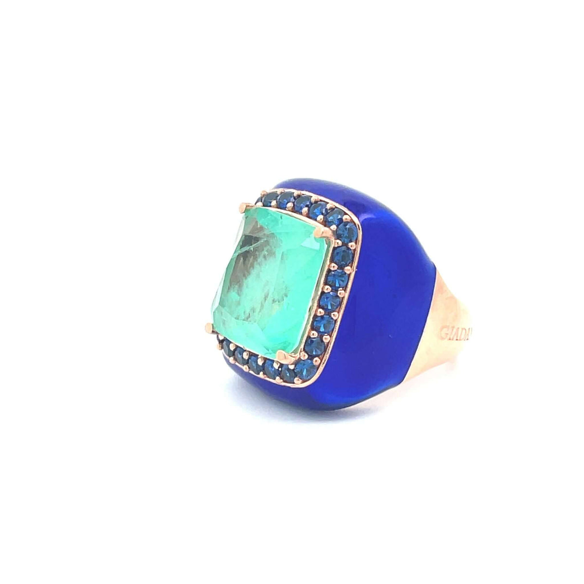 Side view of Laila, rose gold plated statement ring with deep blue enamel, aqua green center stone and deep blue zirconias