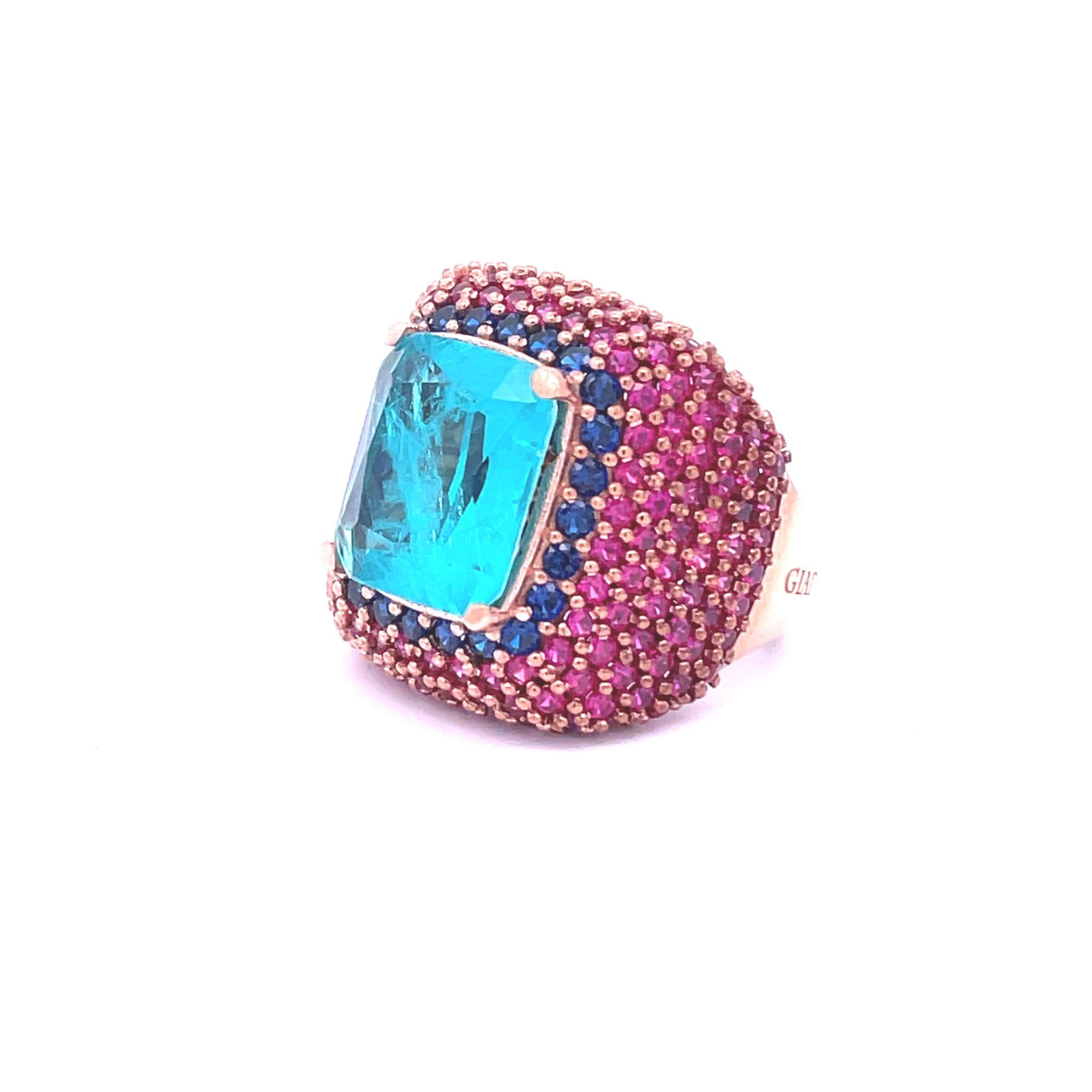 Malika cocktail ring angled view showing 22 mm width, turquoise blue doublette crown detail and lavish red and dark blue pavé set zirconias.