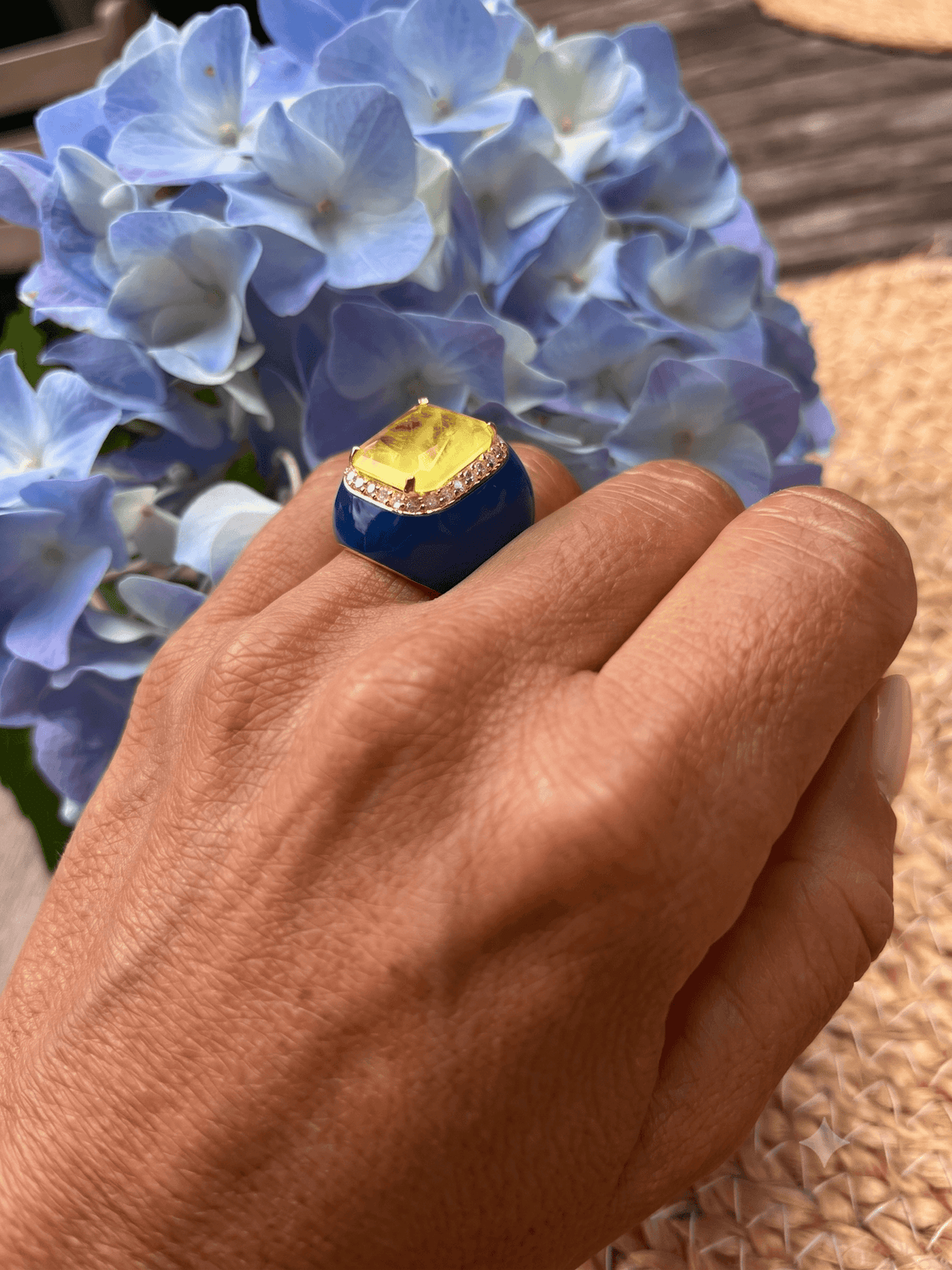 Orguyo ring by Giadan for Le.Paul Jewelgarden — deep blue enamel statement ring with yellow doublette center stone worn on hand