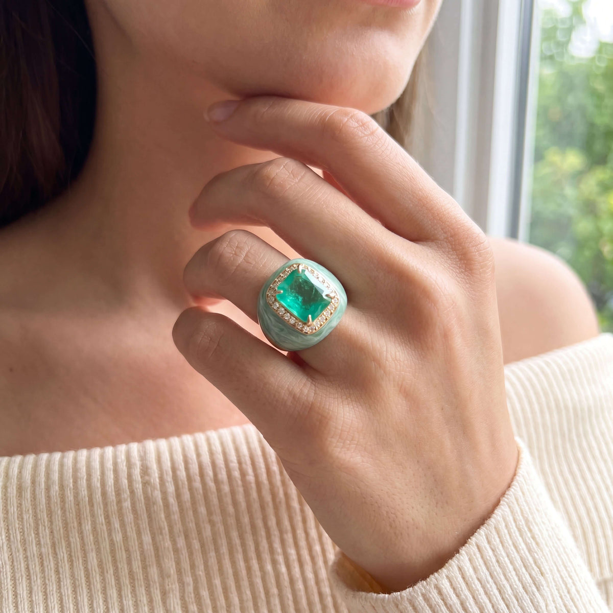 VALENTINA statement ring worn on a hand, aqua green center stone with marbled light green enamel and champagne pavé, yellow gold plated. GIADAN for Le.Paul Jewelgarden