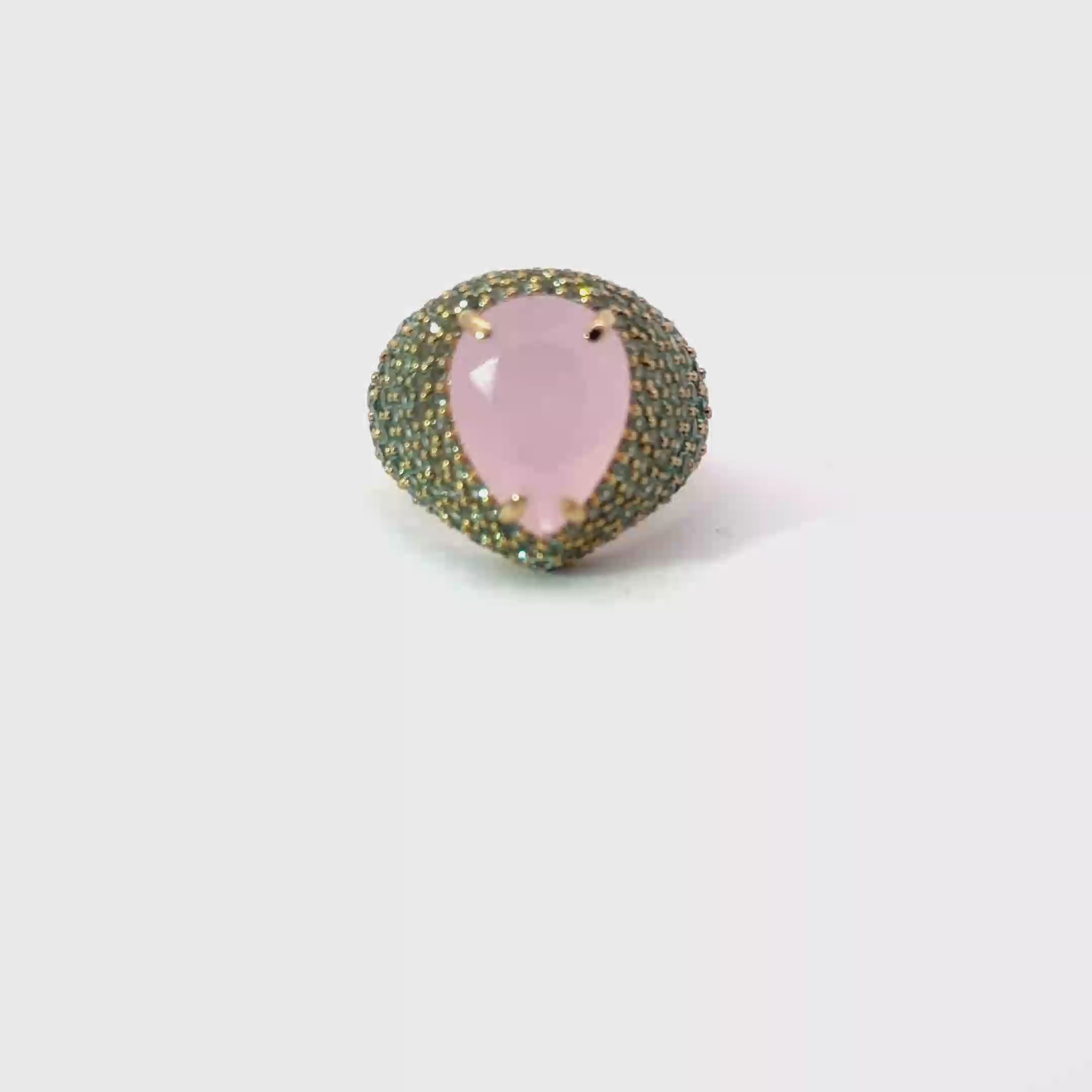 CELESTE statement ring, 360 degree rotating view, pear-cut pale pink center stone with green pavé zirconias, yellow gold plated